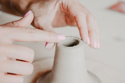 Cropped hand of woman working in workshop