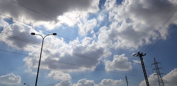 Low angle view of electricity pylon against sky