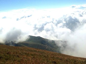 Scenic view of mountains against cloudy sky