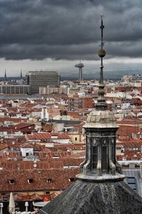 Cityscape against cloudy sky