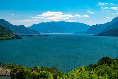 Scenic view of sea and mountains against sky