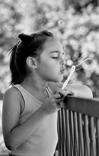 Close-up portrait of girl holding outdoors