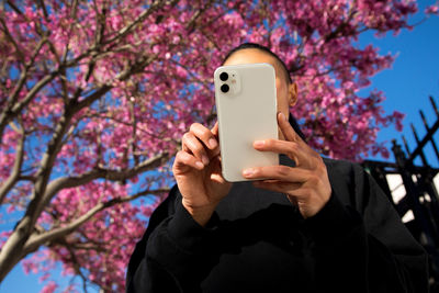 Woman using cell phone outdoors in nature