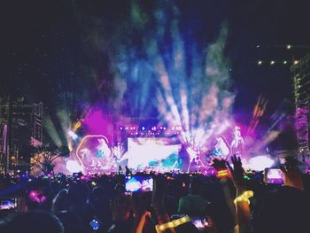 People enjoying music concert at night