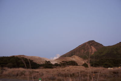 Scenic view of field against clear blue sky