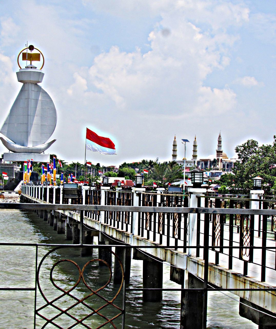 PIER OVER RIVER AGAINST BUILDINGS