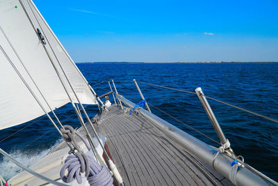 Sailboat sailing in sea against sky