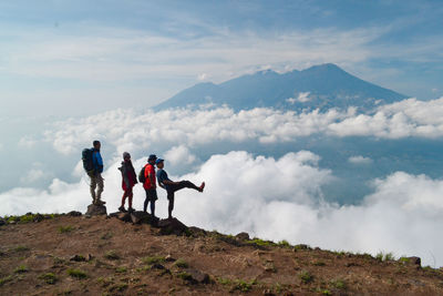 Men on mountains against sky