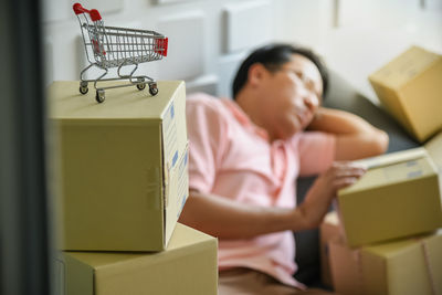 Full length of woman sitting in box