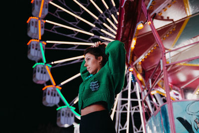 Portrait of young woman sitting on slide