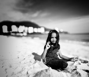 Portrait of woman sitting on beach