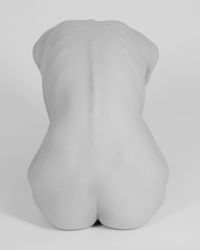 Rear view of shirtless woman against white background