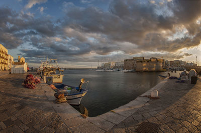 Panoramic view of buildings and sea against sky during sunset