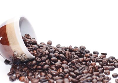 Close-up of coffee beans against white background