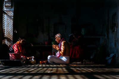 People sitting in corridor of building