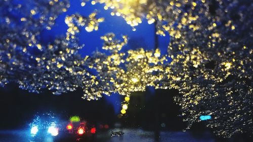 View of illuminated street in city at night