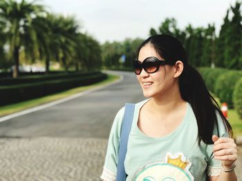 Portrait of smiling young woman wearing sunglasses