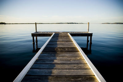 Pier over lake against sky