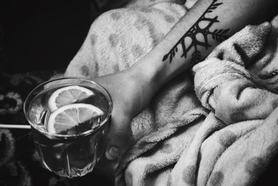 Cropped image of man holding drinking glass