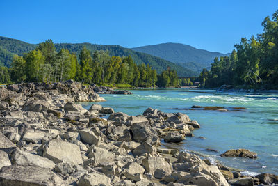 Scenic view of rocks in mountains against clear sky