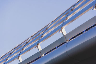 Low angle view of metallic structure against clear blue sky