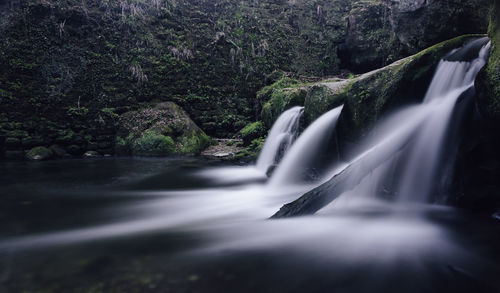 Water flowing through rocks in forest