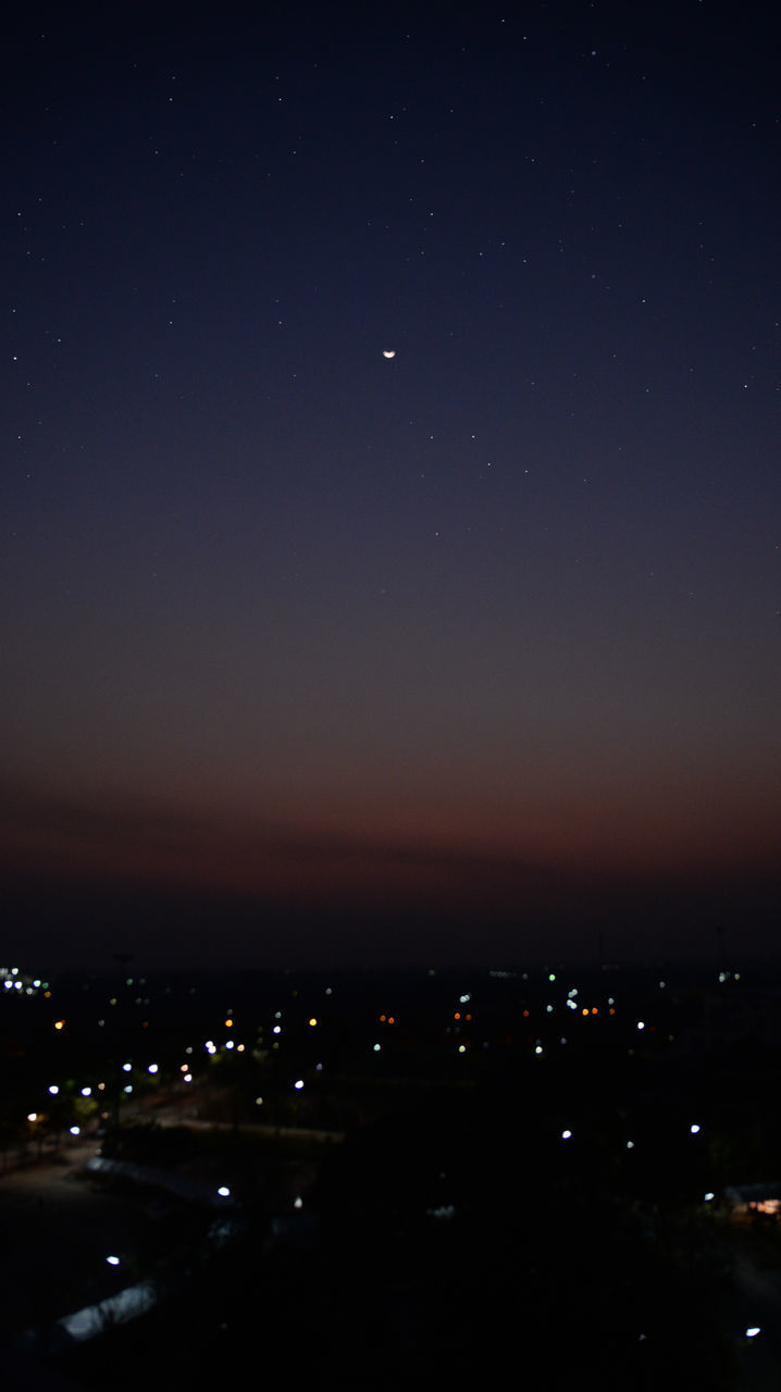 ILLUMINATED CITYSCAPE AGAINST SKY AT NIGHT