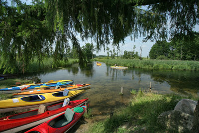 Boats moored in lake against sky