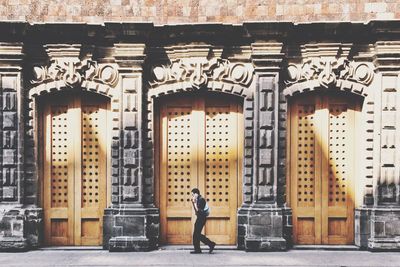 Full length of woman standing in front of building