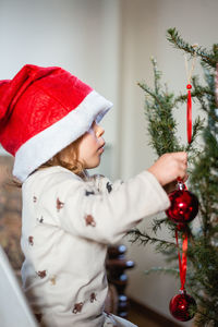 Midsection of woman holding christmas decoration