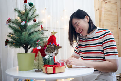 Portrait of young woman sitting at home