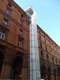 Low angle view of old building against clear blue sky