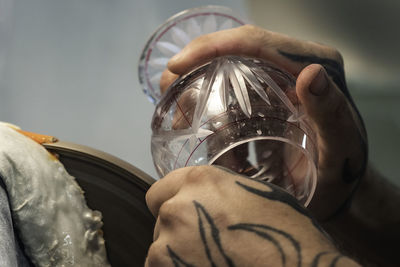 Close-up of man holding glass
