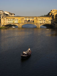Boats in river in city