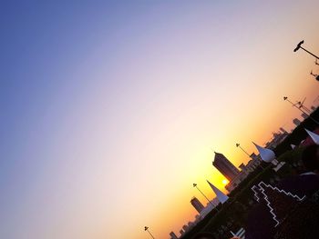 Low angle view of silhouette birds flying against sky