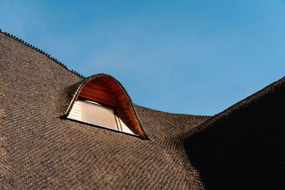 Low angle view of traditional roof of building against clear sky