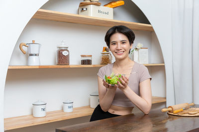 Portrait of young woman sitting at home