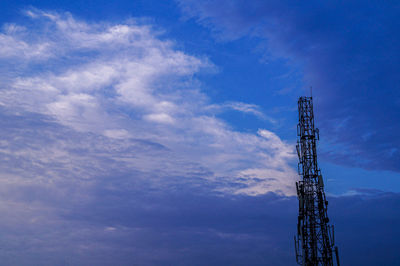 Low angle view of communications tower against sky