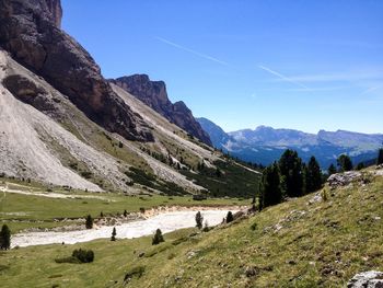 Scenic view of mountains against blue sky