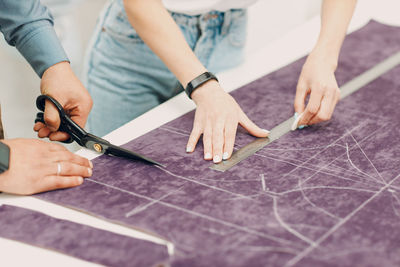 Midsection of man working on table