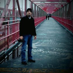 Full length of woman standing on railing