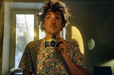 Young woman standing against wall