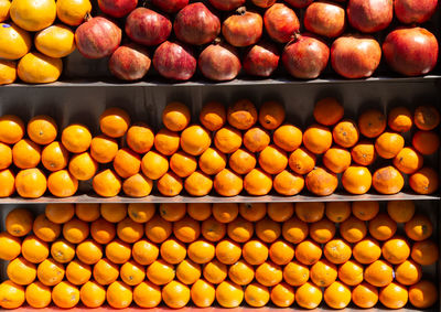 Bunch of bright color oranges on market stall as ripe juicy tro