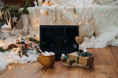 View of laptop with christmas decoration on floor at home