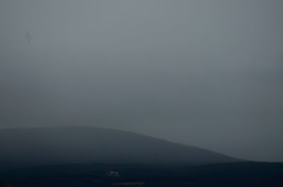 Scenic view of silhouette landscape against sky at night