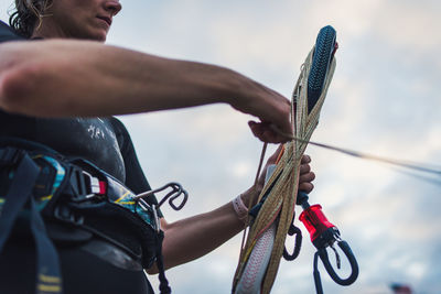 A woman wrapping up her kiteboarding line