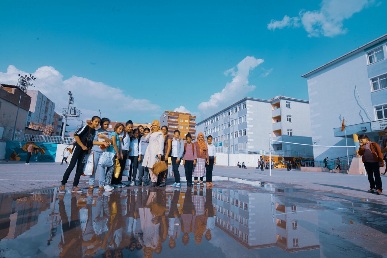 GROUP OF PEOPLE WALKING ON STREET IN CITY