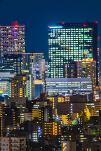 Illuminated modern buildings in city at night
