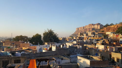 Buildings in city against clear sky