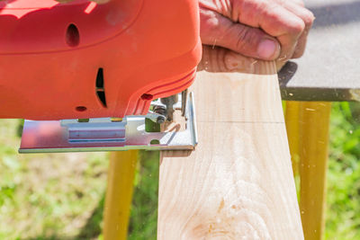Close-up of man working on wood
